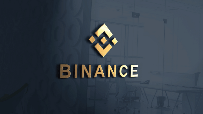 binance exchange logo on wall min 1 - همه چیز درباره ی صرافی بایننس (Binance)